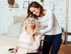 caregiver and a senior looking at each other while smiling
