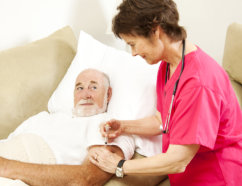nurse checking blood pressure to a senior man