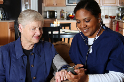 nurse measuring senior's blood pressure